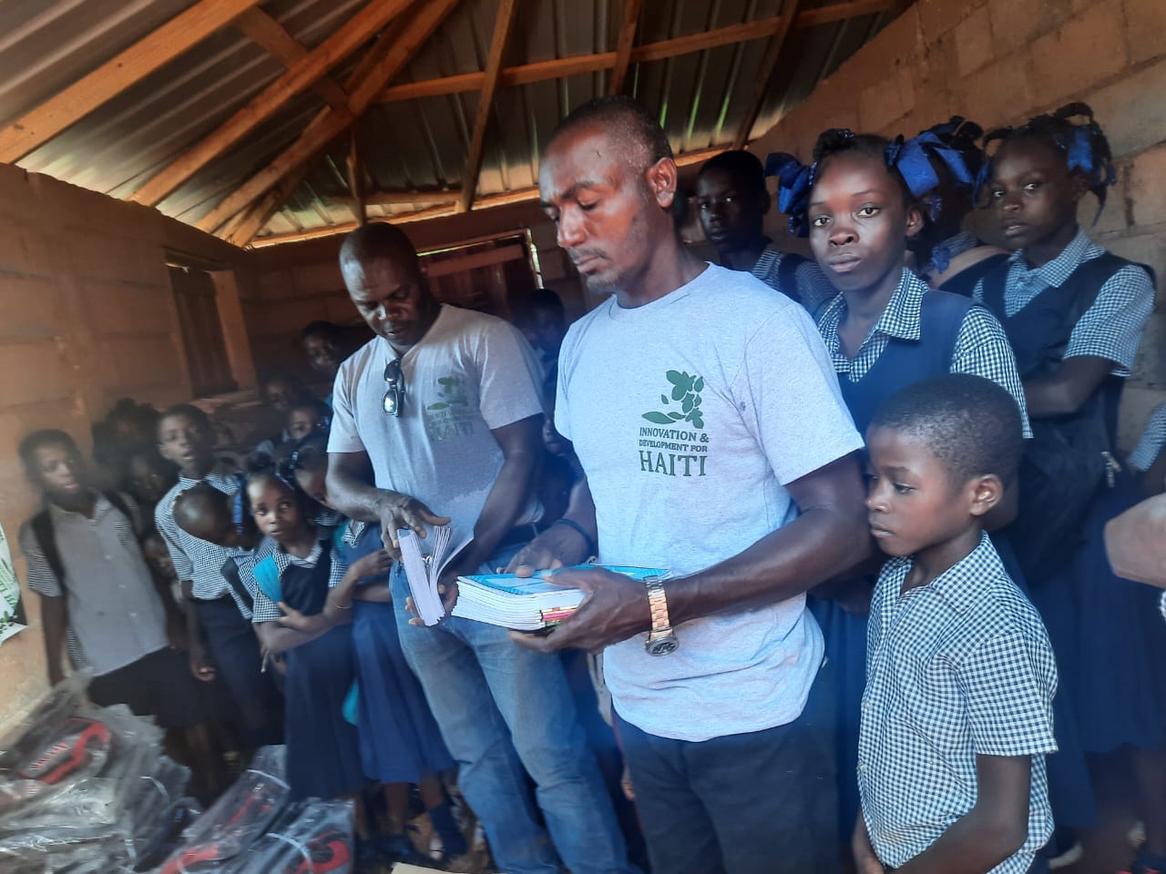 Haitian man holding books in school